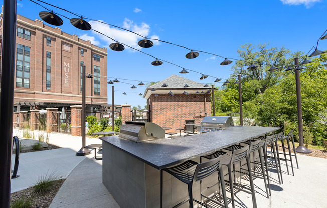 a communal bar with chairs and a building in the background