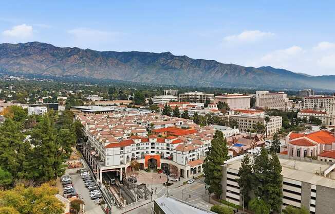 A cityscape with a church and mountains in the background.