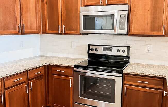 a kitchen with wooden cabinets and stainless steel appliances