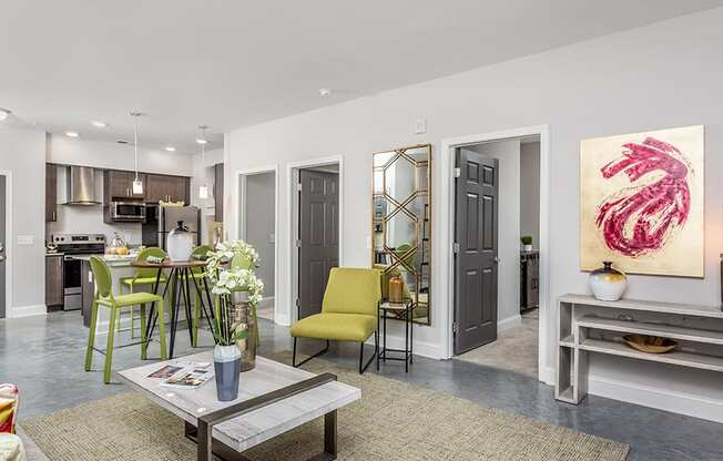 a living room and kitchen with a table and chairs