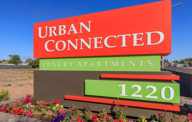 a sign that reads urban connected luxury apartments in front of a road