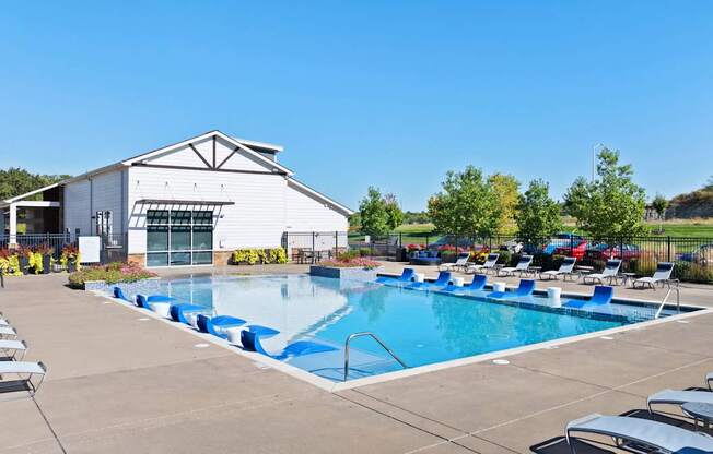 A large white building with a pool in front.