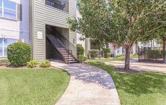 Exterior view of residential building with garage at The Avenue apartmentsÂ