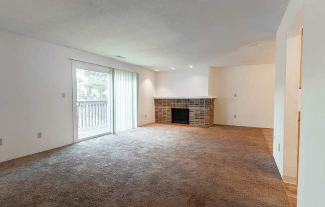the living room of an empty house with a fireplace