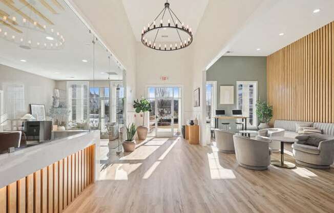 A modern office lobby with a reception desk and seating area.