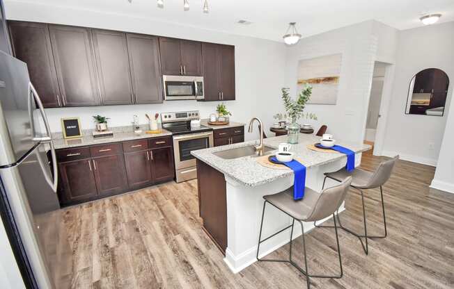 a kitchen and dining area with a table and chairs