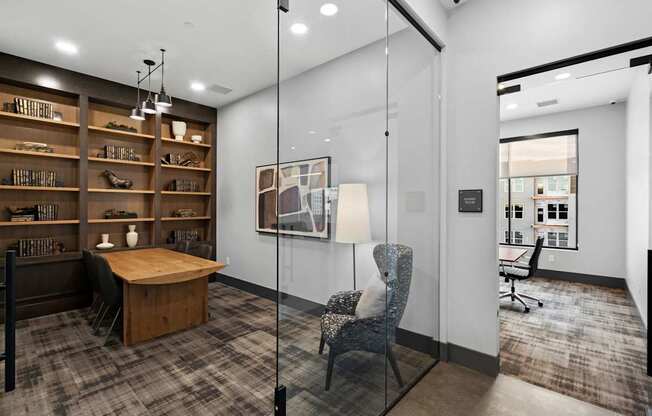A modern office space with a wooden desk, a chair, and a bookshelf.