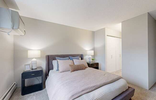 a bedroom with a queen bed and closet