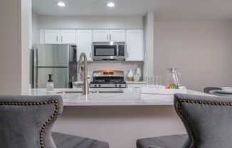 The Residence at Christopher Wren apartments kitchen with stainless appliances and white cabinetry