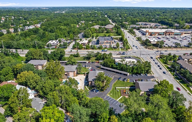 an aerial view of a city with cars and trees