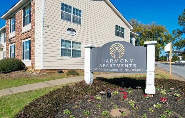 the apartments entrance sign in front of the building