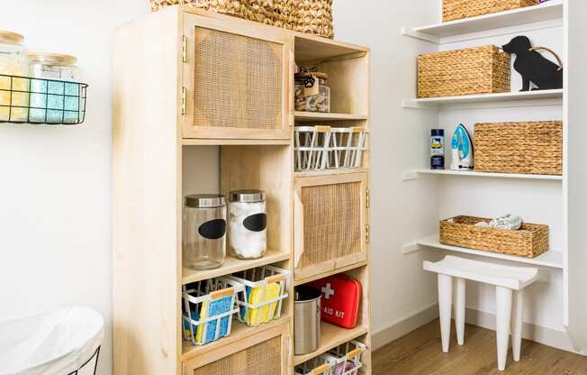 a room with a wooden shelf with baskets and other items on it