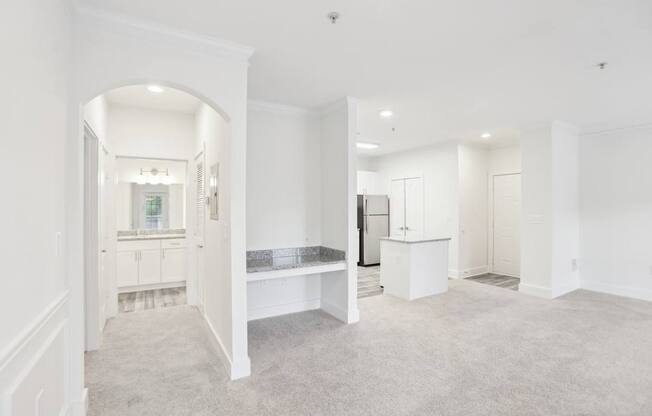 Living and dining area with a view of  a hutch desk and bathroom