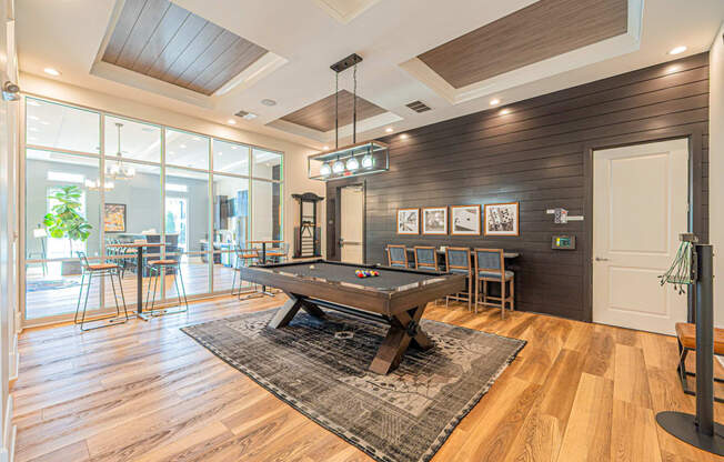 a game room with a pool table and a bar