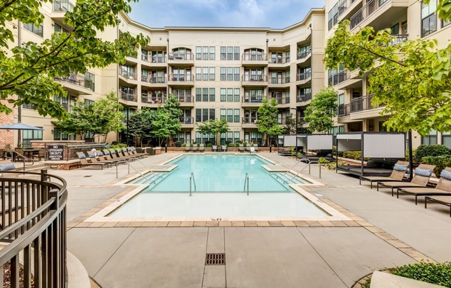 a swimming pool in front of an apartment building