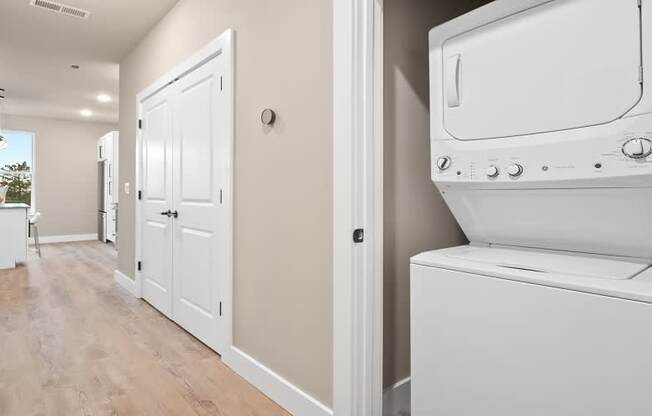 A white washing machine is in a laundry room.