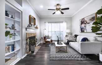 Mesa Verde Rooms Living Room with Wood Look Vinyl Flooring Fireplace Built In Shelves and Ceiling Fan