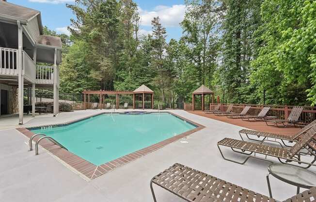 A pool with lounge chairs and tables