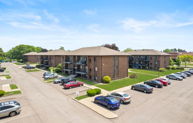 a brick apartment building with a parking lot in front of it at Lafayette Park Place, Detroit, MI, Detroit, MI, 48207