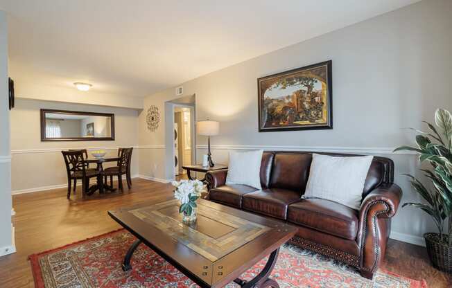 a living room with leather couches and a coffee table