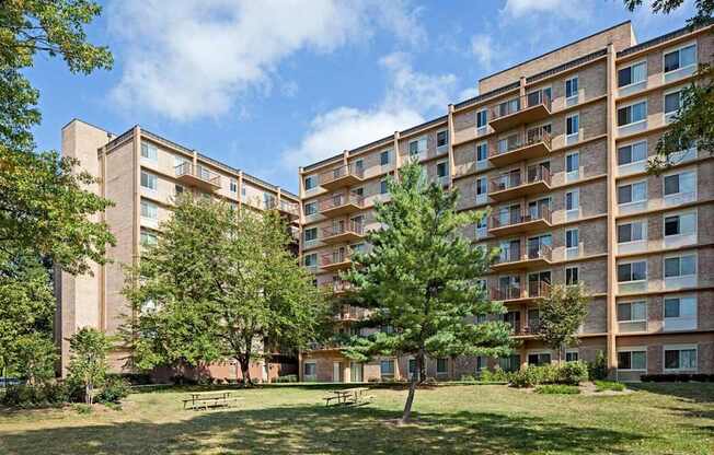 A large grassy area in front of apartment buildings.