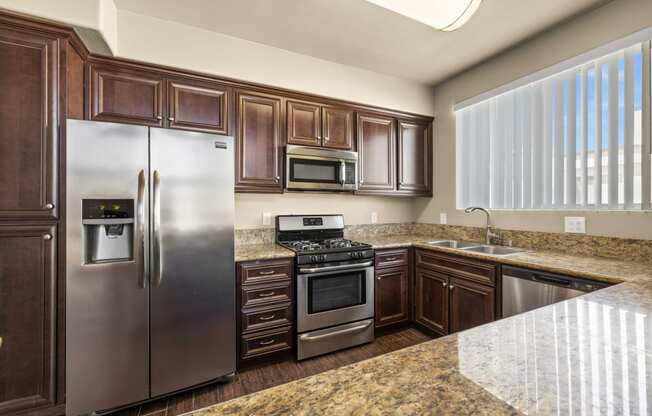 a kitchen with stainless steel appliances and granite counter tops