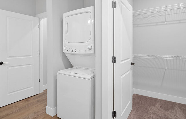 A white fridge and toilet in a small room.