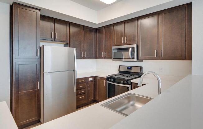 a kitchen with a stainless steel refrigerator freezer and a stove top oven