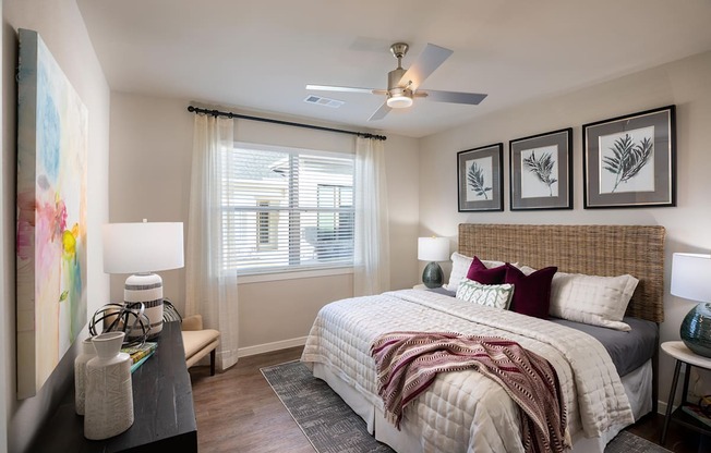 a bedroom with a large bed and a ceiling fan at 55 Fifty at Northwest Crossing, Houston, 77092