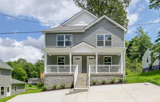 Two Story Duplex With Hardwood Flooring and White Cabinetry
