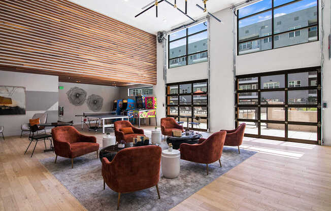 A room with a wooden floor and a long window with a view of a building.