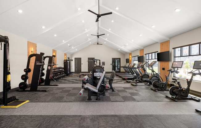 a gym with cardio equipment and weights on a checkered floor