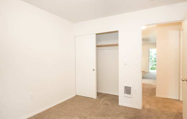 a bedroom with a carpeted floor and white walls