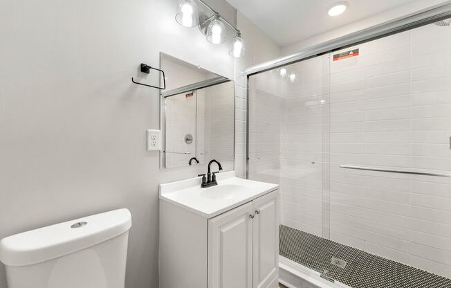 Bathroom with a sink toilet and a shower at Crogman School Lofts, Atlanta, 30315