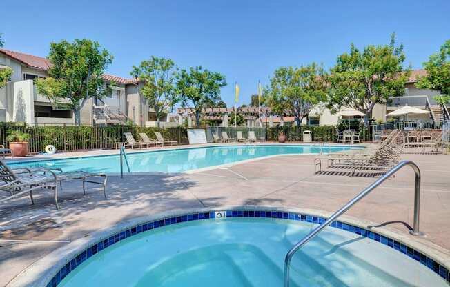 A swimming pool with a ladder and a sun lounger.