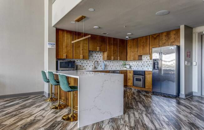 a kitchen with wooden cabinets and a white marble counter top