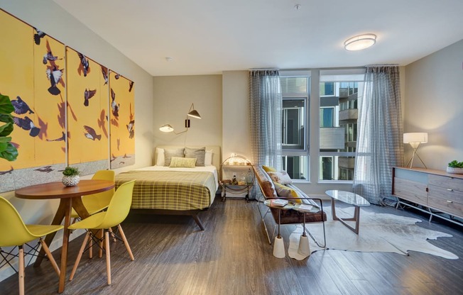 a bedroom with a bed and a living room with a table and chairs at L Seven, San Francisco, CA