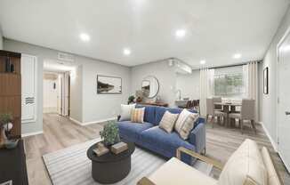 a living room with a blue couch and a dining room table