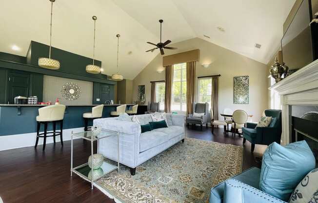 Living room with blue couches and chairs and a kitchen at The Chase, Burlington, NC