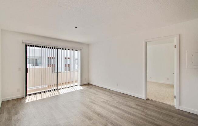 an empty living room with a large window  at Masselin Park West, Los Angeles