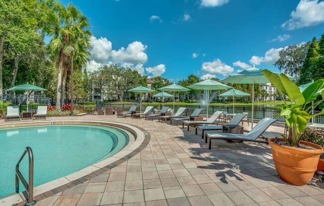 Pool area with lounge seating and umbrellas