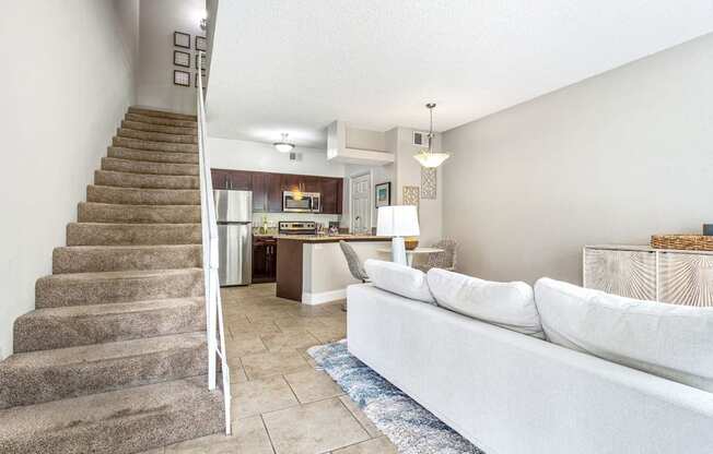 the living room and stairs leading to the kitchen and dining area at Waterford Park Apartment Homes, LLC, Lauderhill