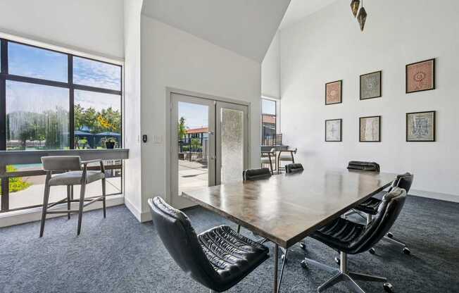 A conference room with a long table and chairs.