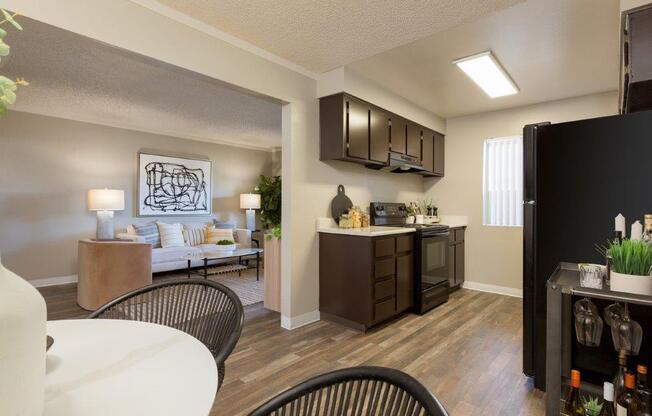 a kitchen and living room with a table and chairs