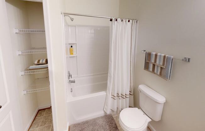 Bathroom with sink, toilet, shower and tub; linen closet
