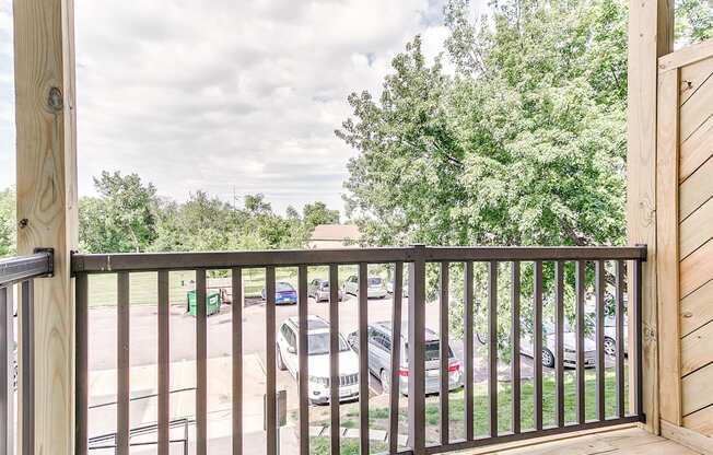 the balcony has a view of the parking lot