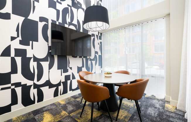 a dining room with a table and chairs and a television