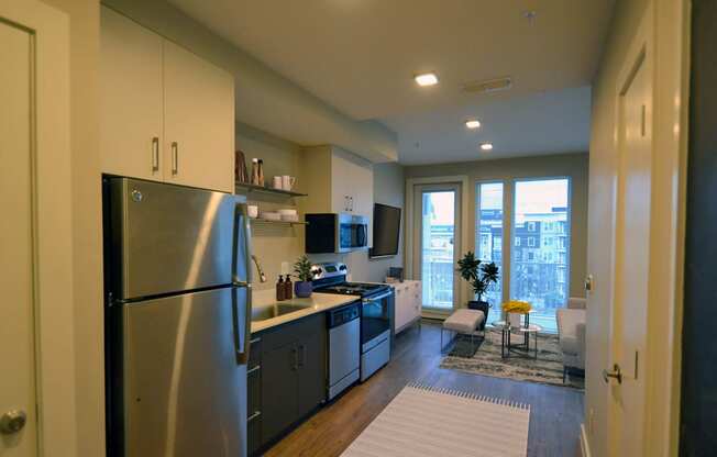 a kitchen and living room in a 555 waverly unit at Link Apartments® Canvas, Atlanta, 30312