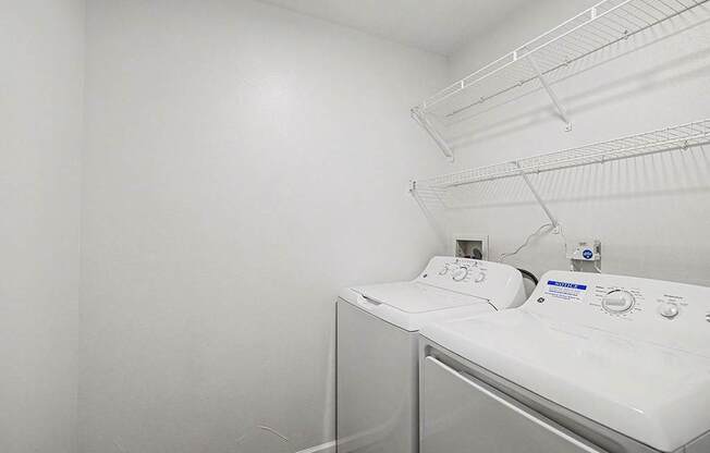 A laundry room with a full size washer and dryer at Brentwood Park Apartments, La Vista, Nebraska