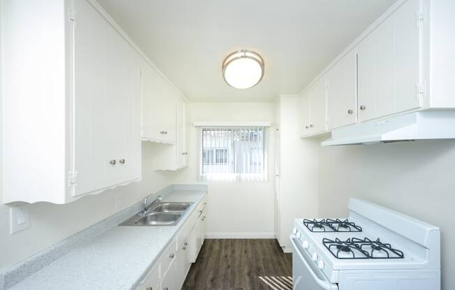 a kitchen with white appliances and white cabinets